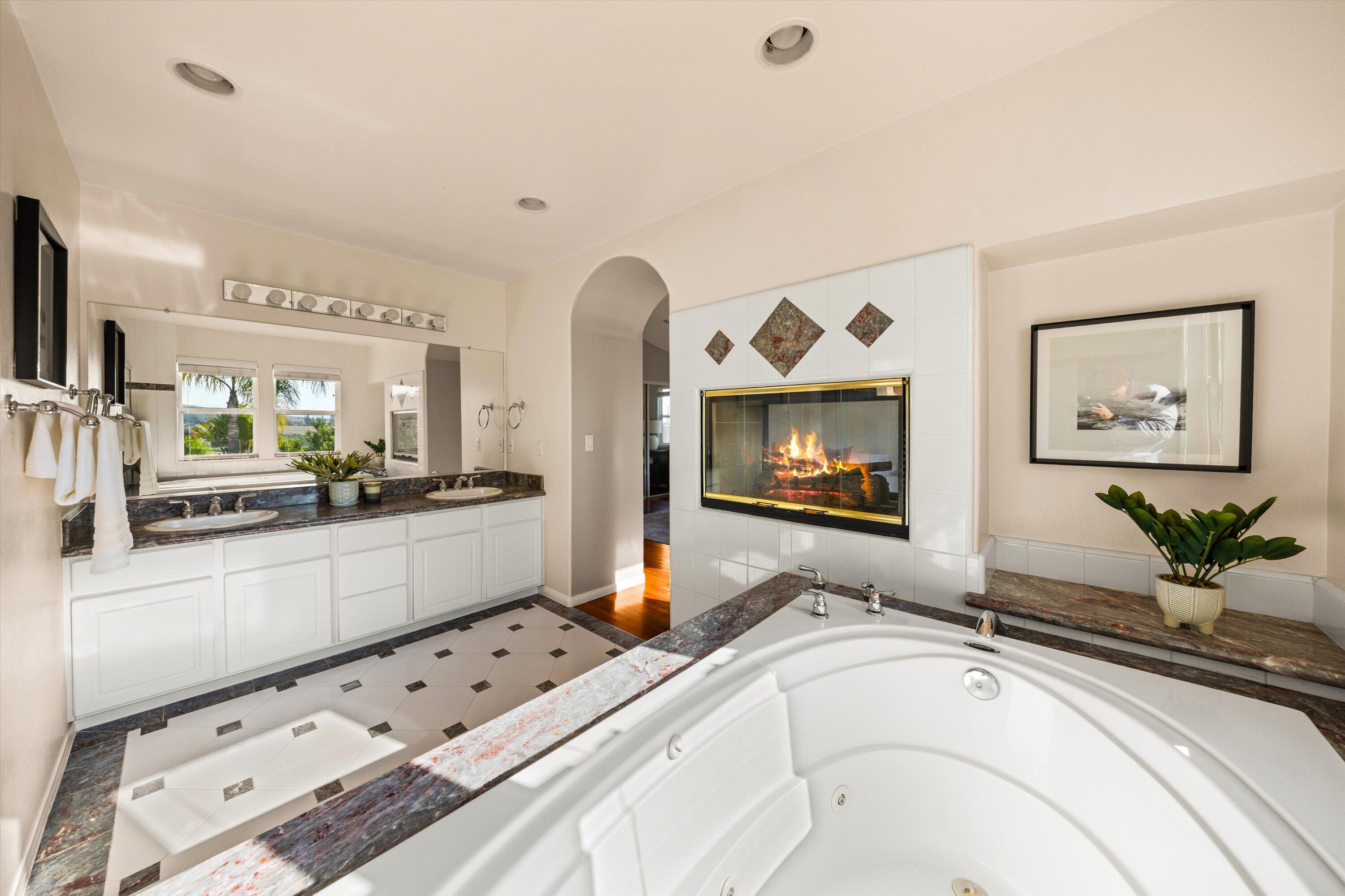 7926 Winchester Circle Goleta, CA 93117 - Photo 23 of 56 a large white kitchen with sink and natural light