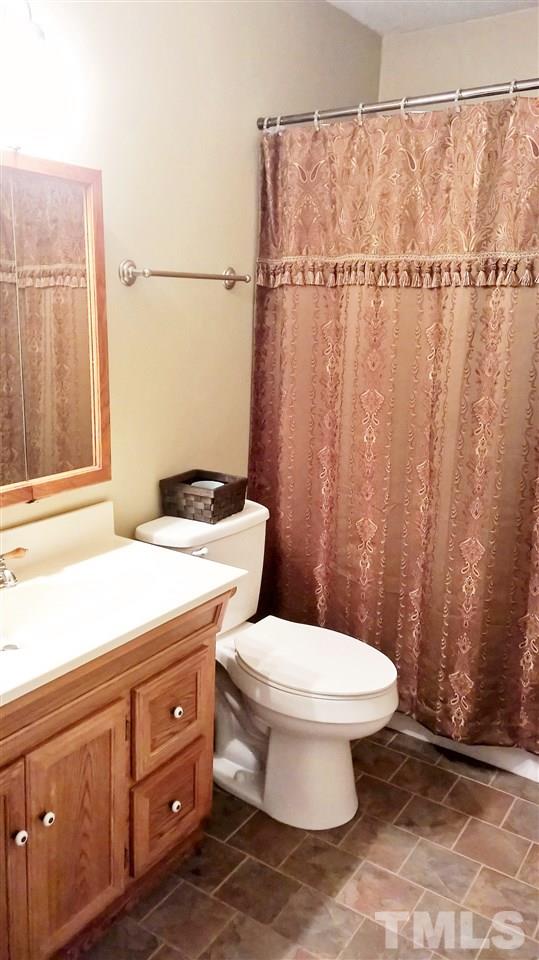 4269 Lake Ridge Drive Raleigh, NC 27604 - Photo 15 of 21 a bathroom with a toilet and a shower