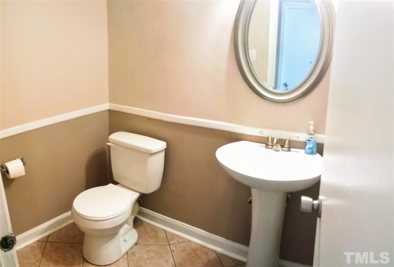 4269 Lake Ridge Drive Raleigh, NC 27604 - Photo 18 of 21 a bathroom with a toilet a sink and a mirror