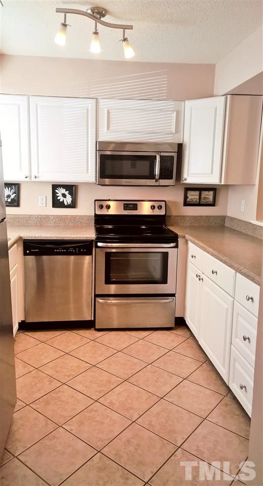 4269 Lake Ridge Drive Raleigh, NC 27604 - Photo 6 of 21 a kitchen with granite countertop a stove and a sink