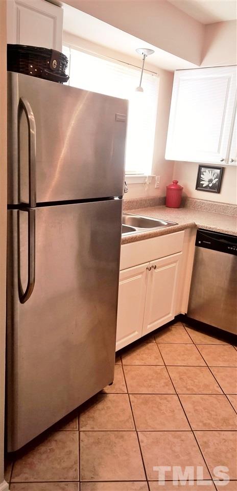 4269 Lake Ridge Drive Raleigh, NC 27604 - Photo 7 of 21 a kitchen with a refrigerator and a stove