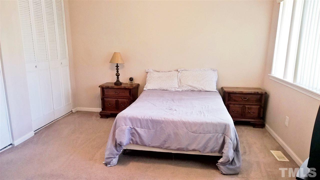 4269 Lake Ridge Drive Raleigh, NC 27604 - Photo 9 of 21 a bedroom with a bed and wooden floor
