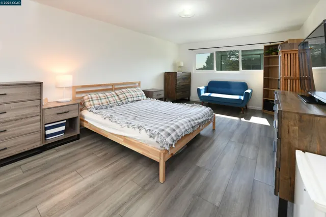 a bedroom with a bed and a television