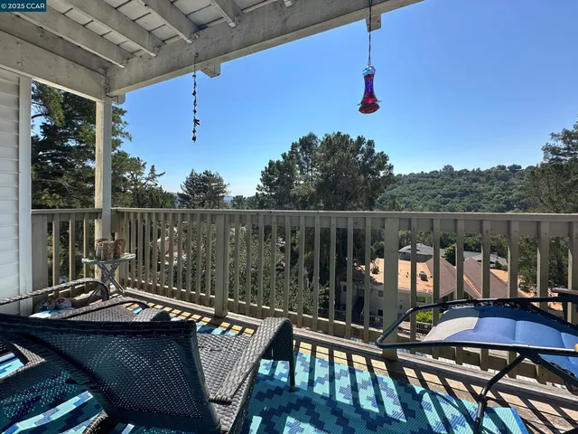 a view of a couches and dinning table in patio