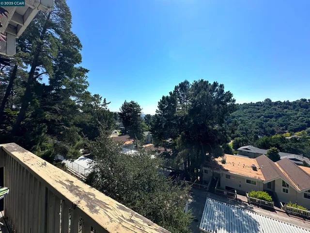 a view of a balcony with wooden fence and floor