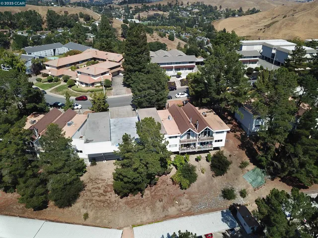 an aerial view of multiple houses with yard
