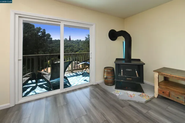 a view of a living room with wooden floor and floor to ceiling window