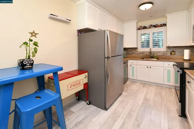 a kitchen with a refrigerator and a sink