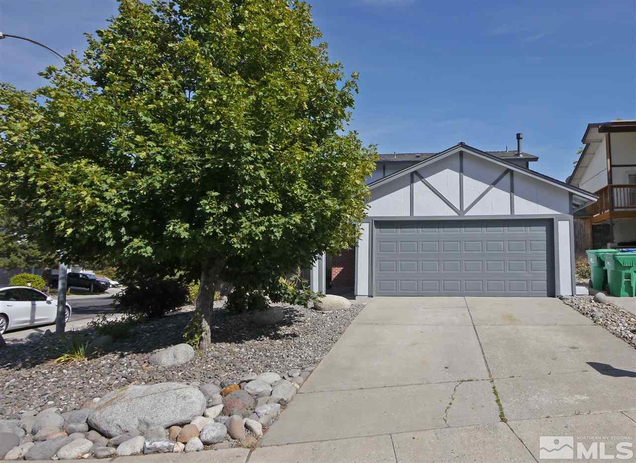 1010 Tudor Court Reno, NV 89503 - Photo 1 of 17 a front view of a house with a yard and garage