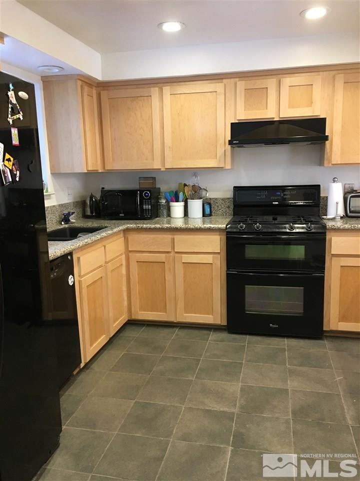 1010 Tudor Court Reno, NV 89503 - Photo 3 of 17 a kitchen with a stove a sink and a window