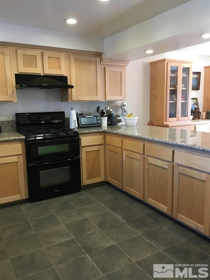 1010 Tudor Court Reno, NV 89503 - Photo 4 of 17 a kitchen with a sink a stove cabinets and a window