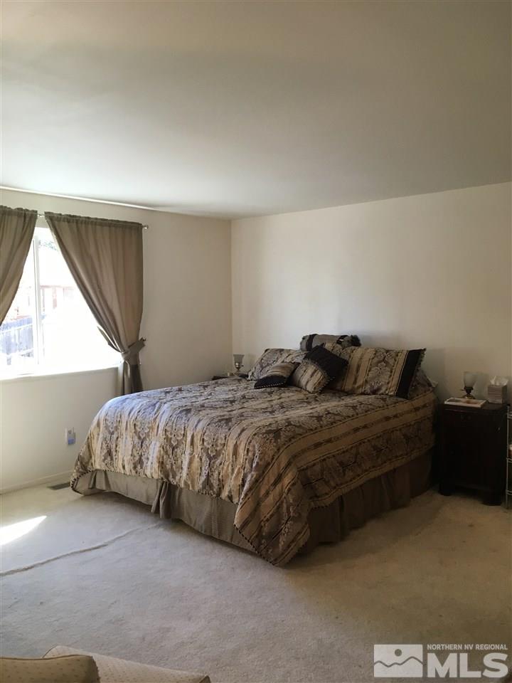 1010 Tudor Court Reno, NV 89503 - Photo 7 of 17 a bed sitting in a bedroom next to a window