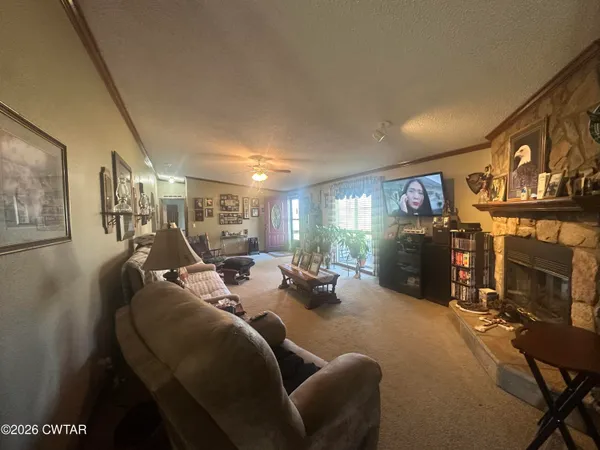 a view of a livingroom with furniture and a flat screen tv