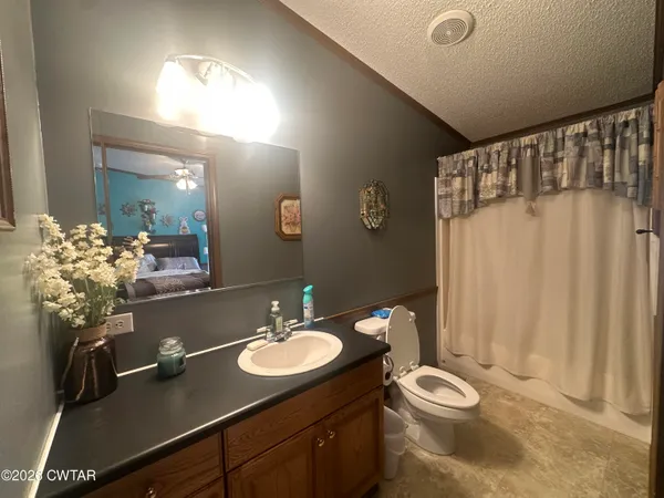 a bedroom with a bed and ceiling fan
