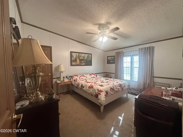 a bedroom with a bed and a dresser with mirror