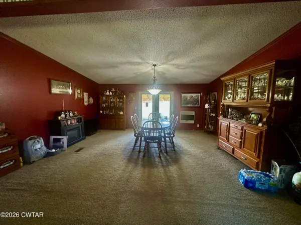 a dining room with furniture and a chandelier