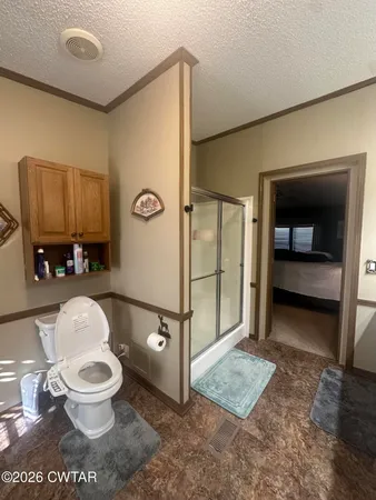 a bathroom with a toilet and a shower