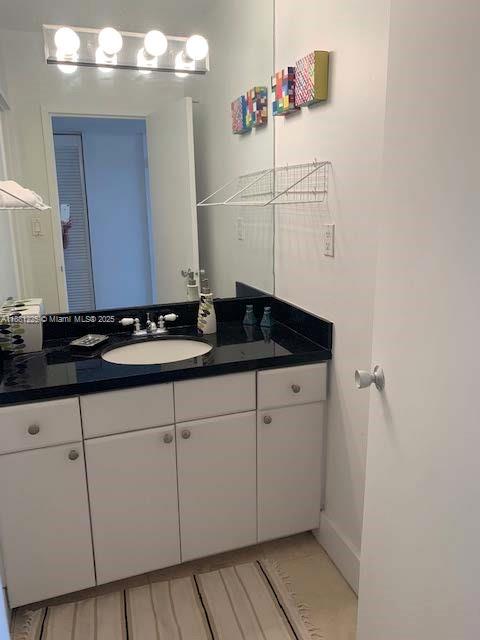 100 Lincoln Road, Unit 1438 Miami Beach, FL 33139 - Photo 11 of 31 a bathroom with a sink and cabinets