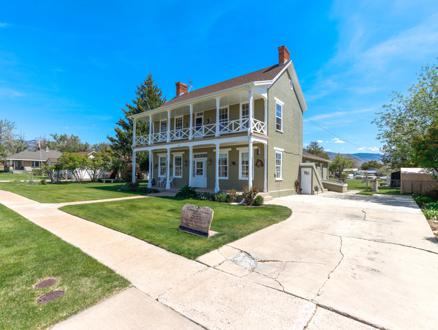 155 West Center Street Fillmore, UT 84631 - Photo 5 of 86 Two-story traditional residence featuring a full-width covered porch with upper-level balcony, white columns, and balusters