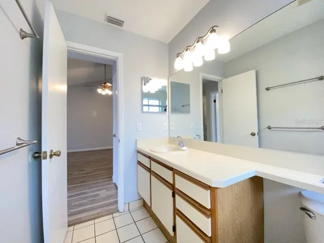 a bathroom with a sink a vanity and a mirror