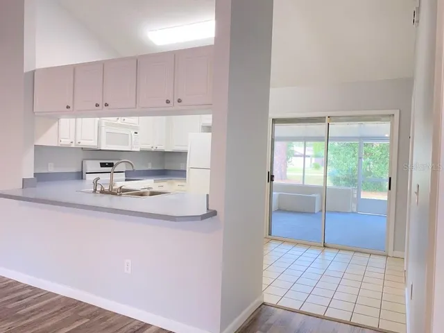 a kitchen with stainless steel appliances granite countertop a sink and a stove top oven