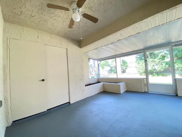 a view of room with window and a ceiling fan