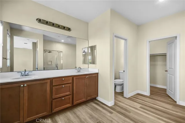 a spacious bathroom with a double vanity sink and a mirror