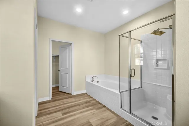 a spacious bathroom with a bathtub and a shower