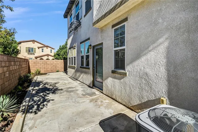 a view of a house with a floor to ceiling window and outdoor kitchen