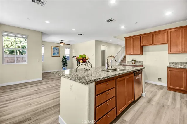 a kitchen with granite countertop a sink and cabinets