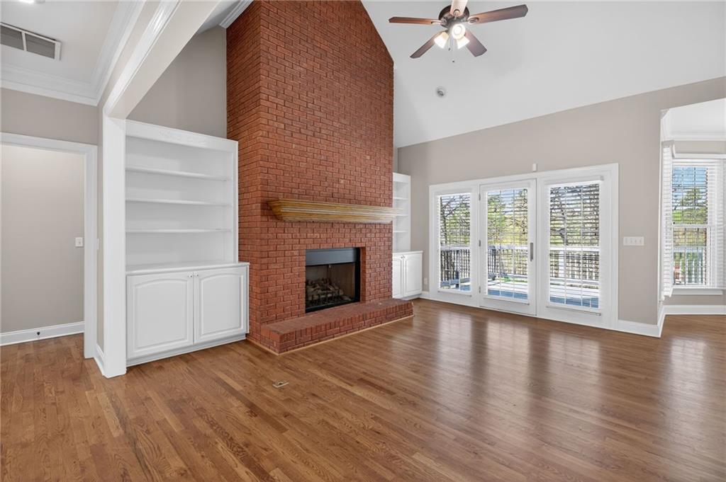 129 Oak Walk Villa Rica, GA 30180 - Photo 13 of 78 a view of an empty room with wooden floor fireplace and a window
