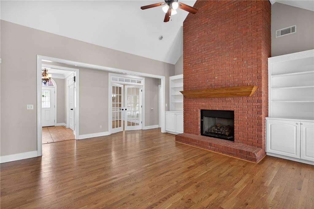 129 Oak Walk Villa Rica, GA 30180 - Photo 16 of 78 a view of an empty room with wooden floor fireplace and a window