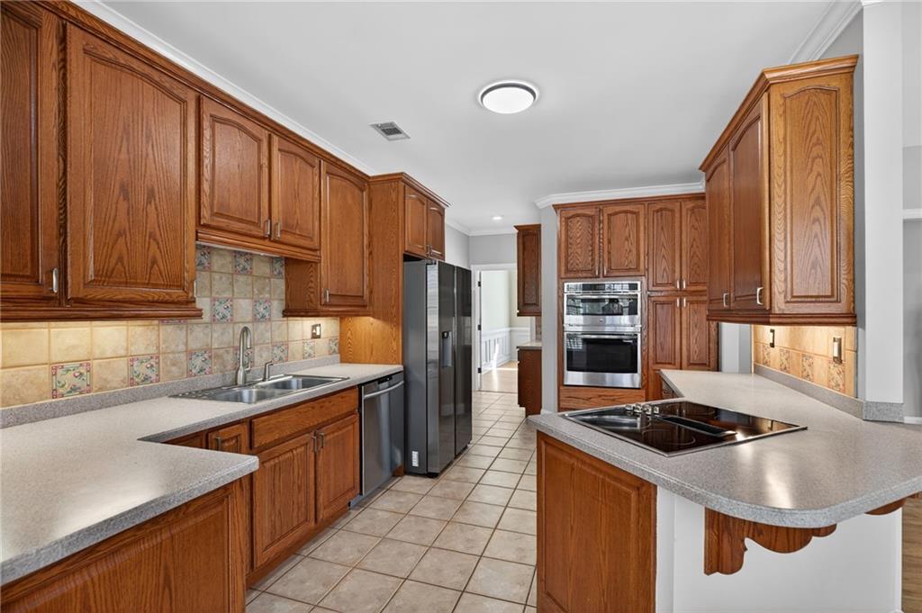 129 Oak Walk Villa Rica, GA 30180 - Photo 19 of 78 a kitchen with stainless steel appliances granite countertop a sink stove and refrigerator
