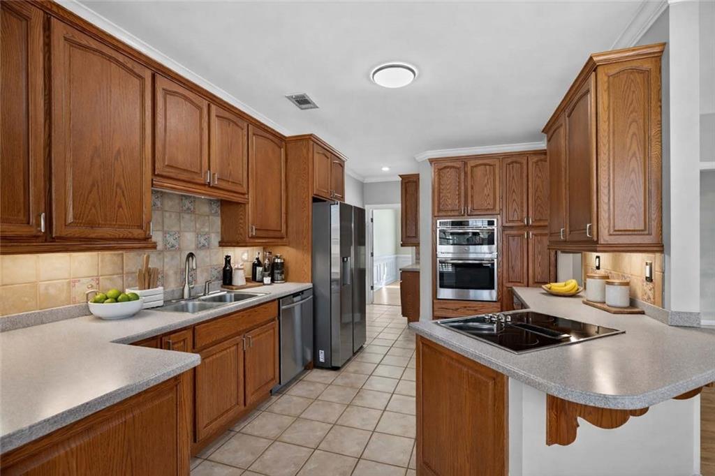 129 Oak Walk Villa Rica, GA 30180 - Photo 20 of 78 a kitchen with kitchen island granite countertop a sink stove and refrigerator