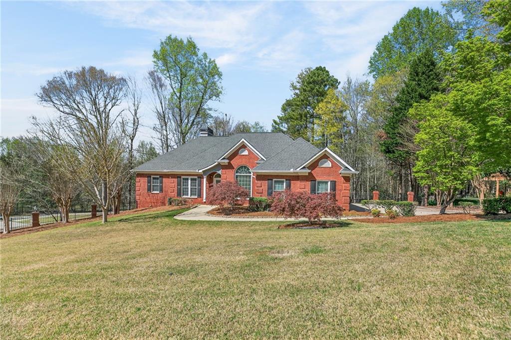 129 Oak Walk Villa Rica, GA 30180 - Photo 2 of 78 a front view of a house with a yard and trees