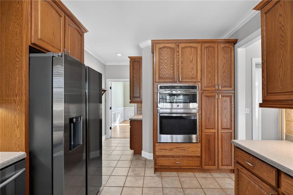 129 Oak Walk Villa Rica, GA 30180 - Photo 21 of 78 a kitchen with stainless steel appliances granite countertop a refrigerator and a stove