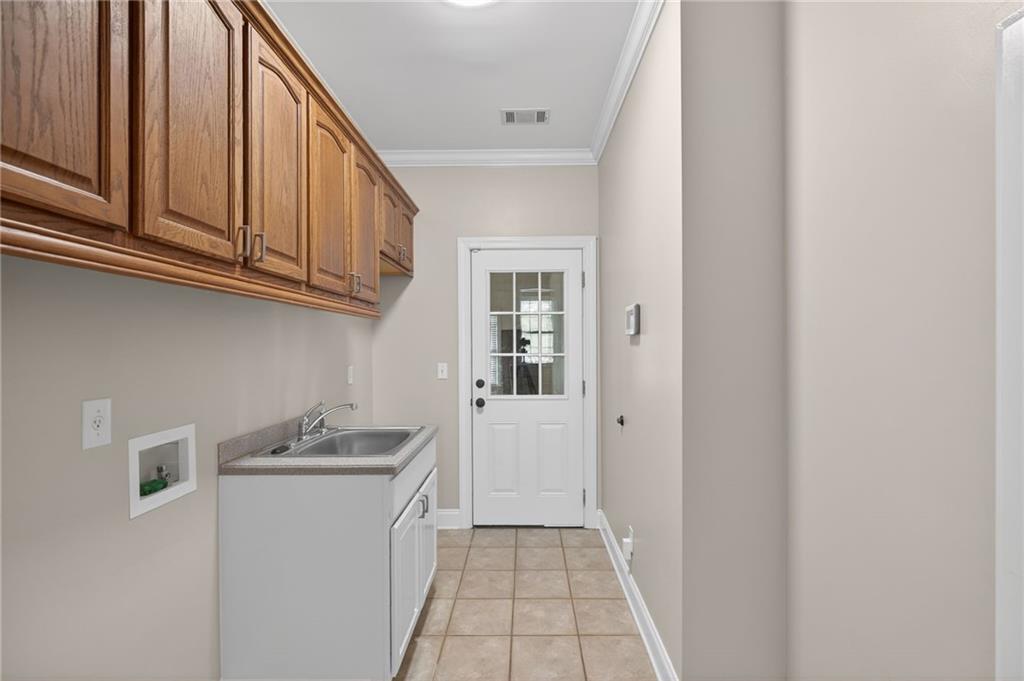 129 Oak Walk Villa Rica, GA 30180 - Photo 27 of 78 a utility room with cabinets washer and dryer