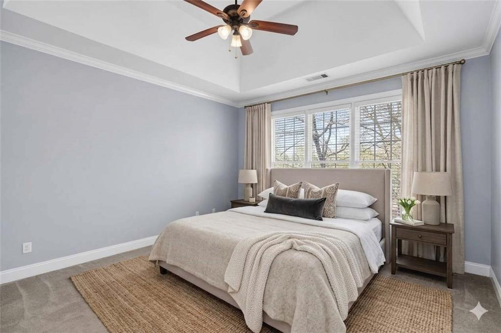 129 Oak Walk Villa Rica, GA 30180 - Photo 30 of 78 a bedroom with a bed and a chandelier