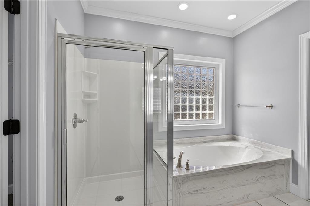129 Oak Walk Villa Rica, GA 30180 - Photo 33 of 78 a spacious bathroom with a tub shower and a sink