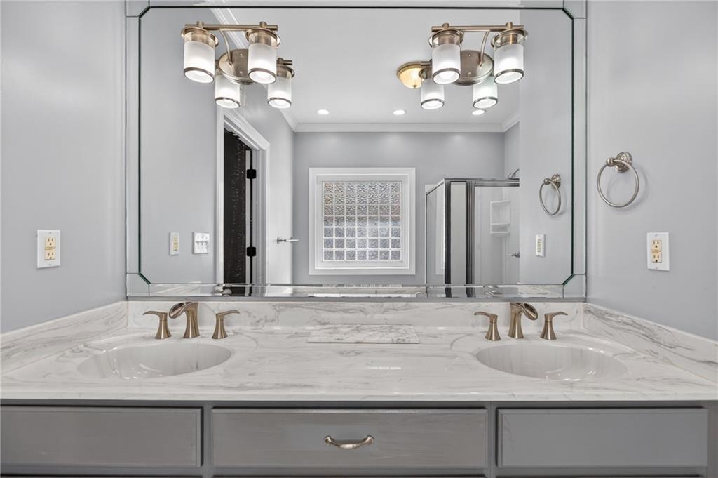 129 Oak Walk Villa Rica, GA 30180 - Photo 34 of 78 a bathroom with a granite countertop sink a large mirror and vanity