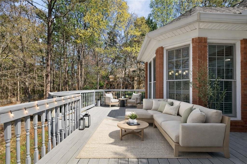 129 Oak Walk Villa Rica, GA 30180 - Photo 42 of 78 a balcony with couches and large trees