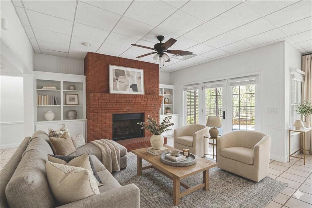 129 Oak Walk Villa Rica, GA 30180 - Photo 49 of 78 a living room with furniture a fireplace and a floor to ceiling window