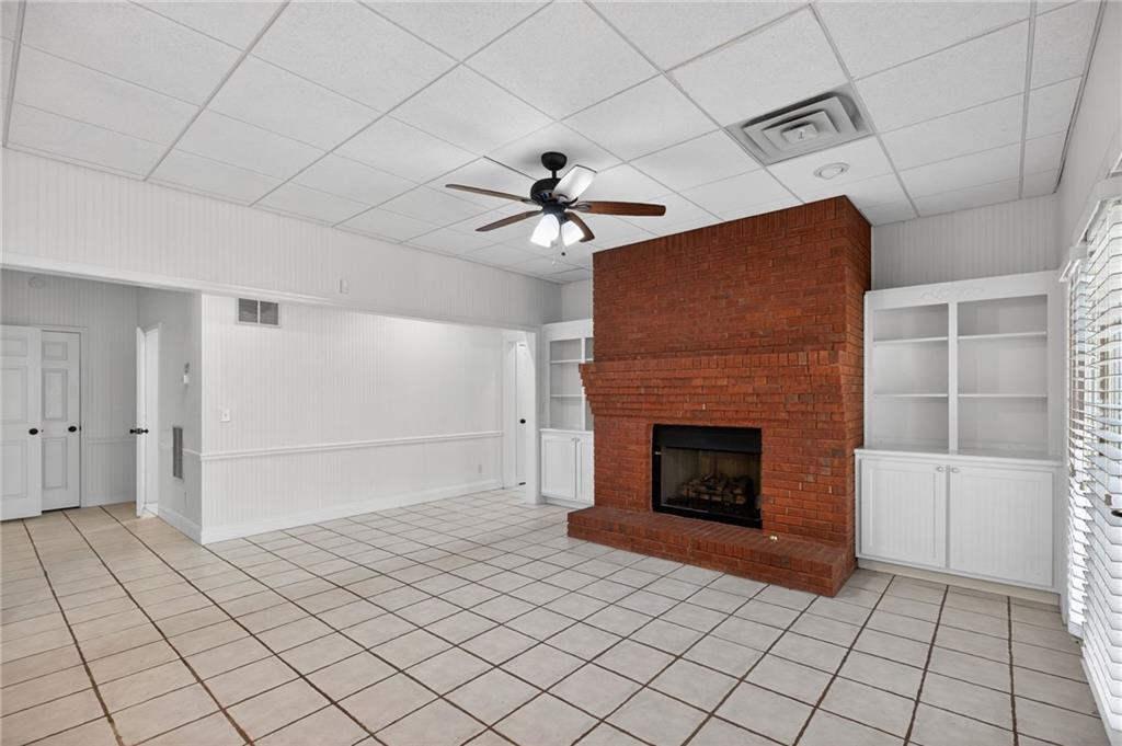 129 Oak Walk Villa Rica, GA 30180 - Photo 50 of 78 a living room with a fireplace furniture and a ceiling fan