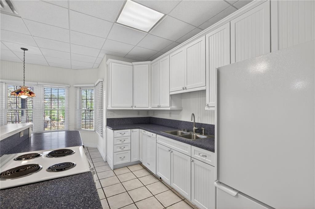 129 Oak Walk Villa Rica, GA 30180 - Photo 52 of 78 a kitchen with granite countertop a sink a stove and cabinets