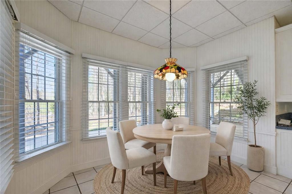 129 Oak Walk Villa Rica, GA 30180 - Photo 55 of 78 a view of a dining room with furniture large windows and wooden floor