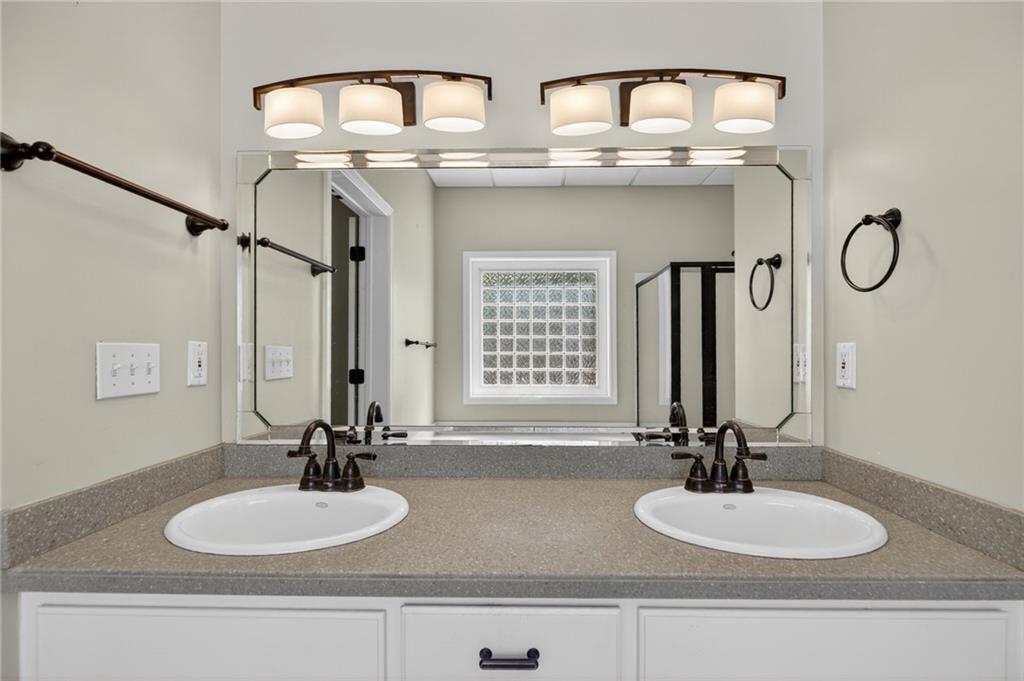 129 Oak Walk Villa Rica, GA 30180 - Photo 60 of 78 a bathroom with double vanity sinks and a mirror