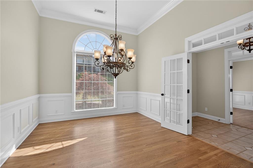 129 Oak Walk Villa Rica, GA 30180 - Photo 8 of 78 a view of a livingroom with wooden floor a chandelier and entryway