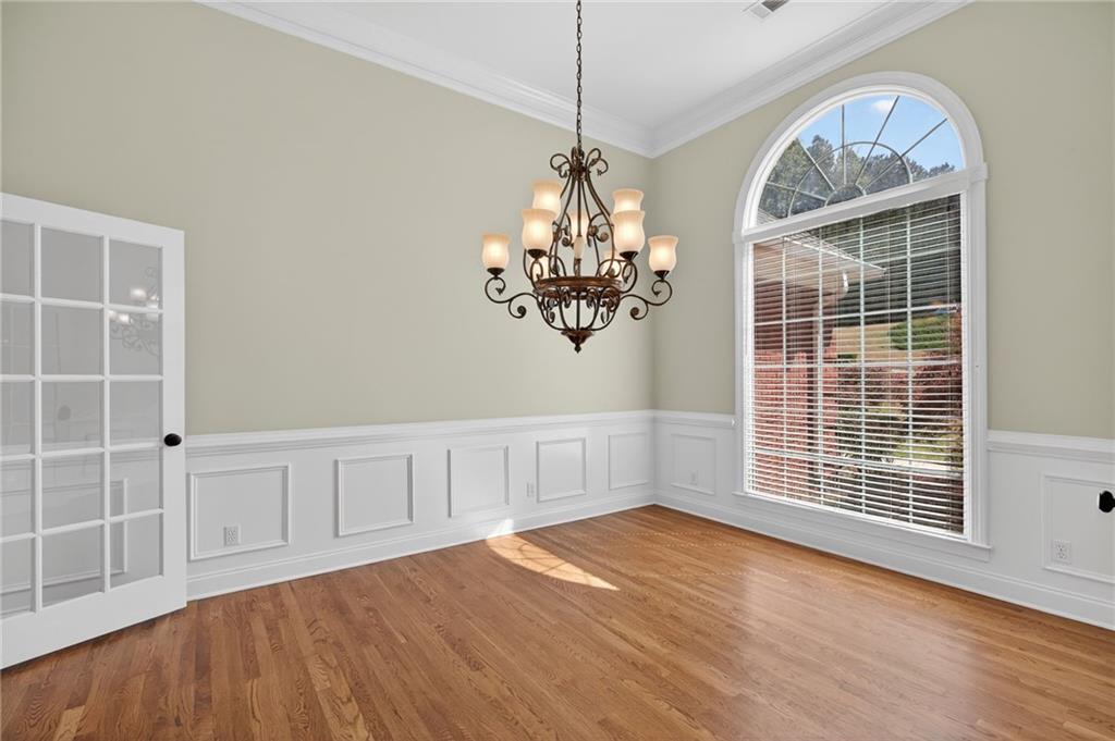 129 Oak Walk Villa Rica, GA 30180 - Photo 9 of 78 a view of an empty room with wooden floor and a window
