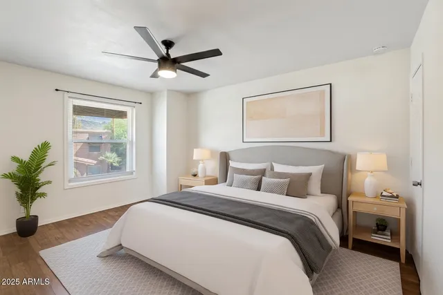 a view of a big room with wooden floor closet a ceiling fan and wooden floor