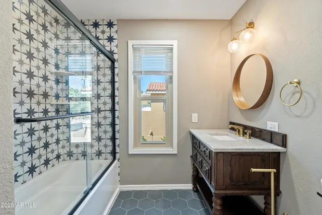 a view of a bathroom with a sink and a mirror